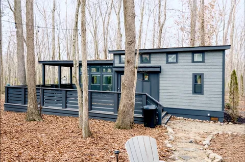 a view of a house with a yard and wooden fence