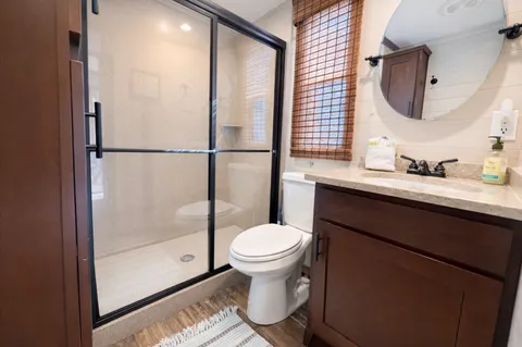 a bathroom with a sink toilet and a mirror