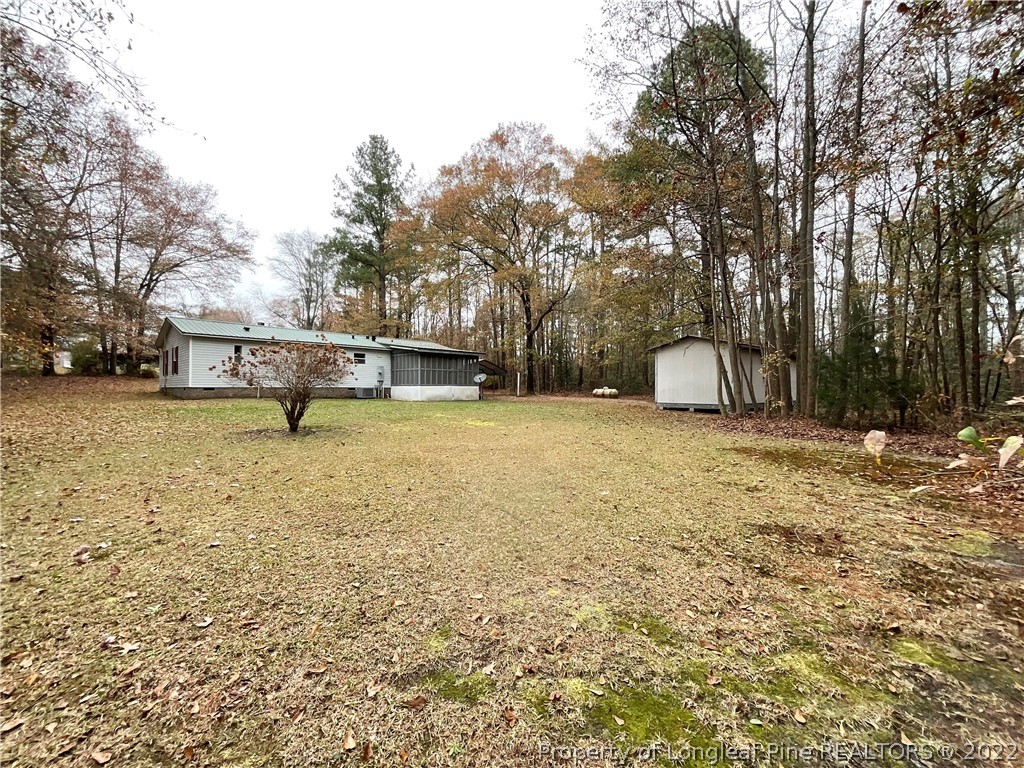 269 Read Road Cameron, NC 28326 - Photo 17 of 21 a view of a house with a yard and sitting area