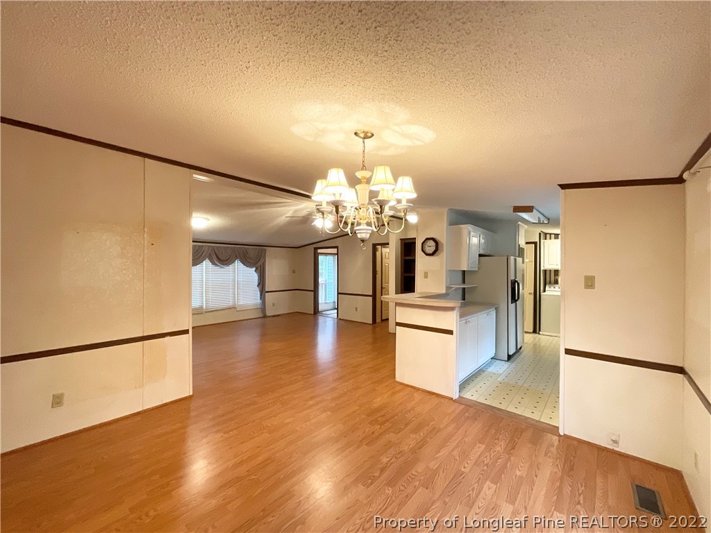 269 Read Road Cameron, NC 28326 - Photo 4 of 21 a view of a kitchen with refrigerator and wooden floor