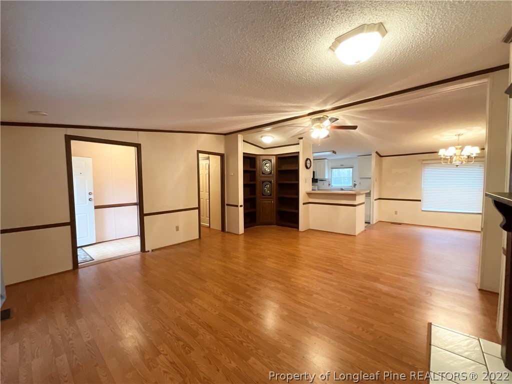 269 Read Road Cameron, NC 28326 - Photo 5 of 21 a view of a big room with wooden floor and a kitchen