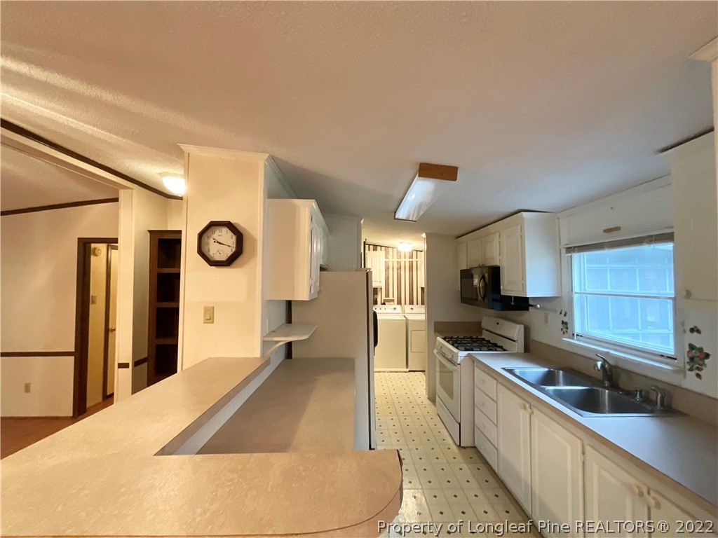 269 Read Road Cameron, NC 28326 - Photo 7 of 21 a large kitchen with kitchen island a large counter top space a sink a stove and a shower