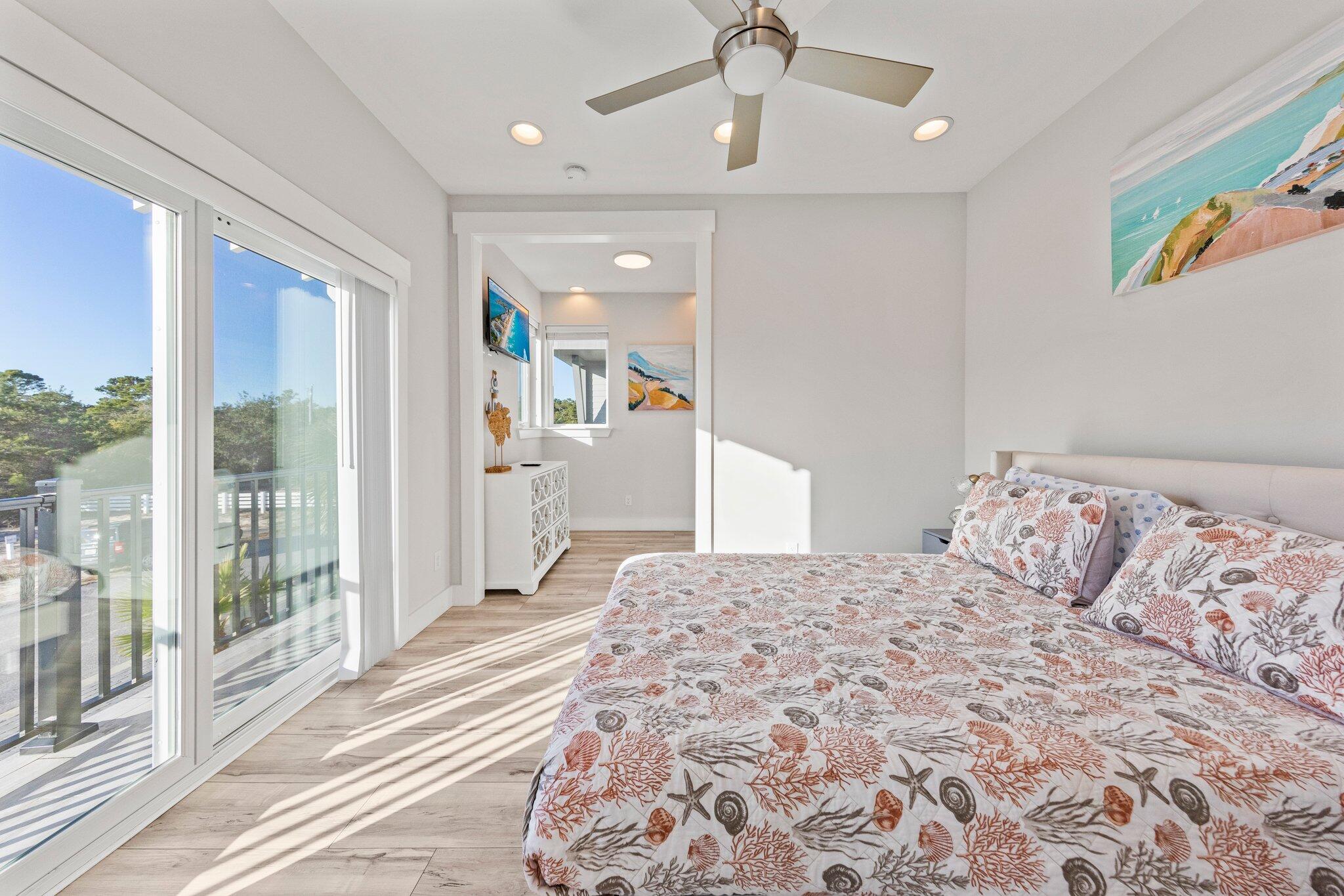 29 Seaview Dr Inlet Beach Inlet Beach, FL 32461 - Photo 14 of 52 a bedroom with a large bed and a chandelier