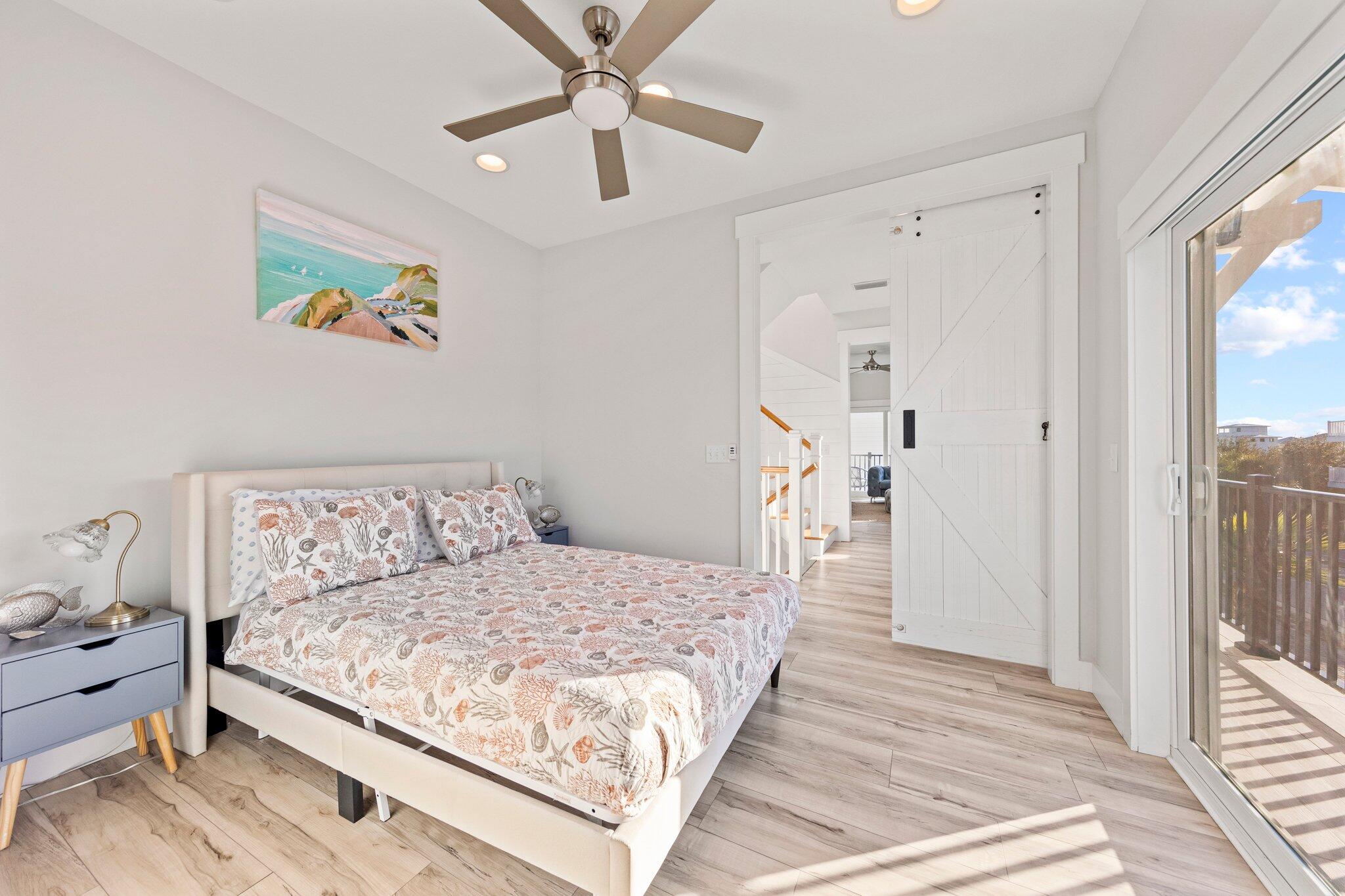 29 Seaview Dr Inlet Beach Inlet Beach, FL 32461 - Photo 16 of 52 a bedroom with a large bed and a chandelier