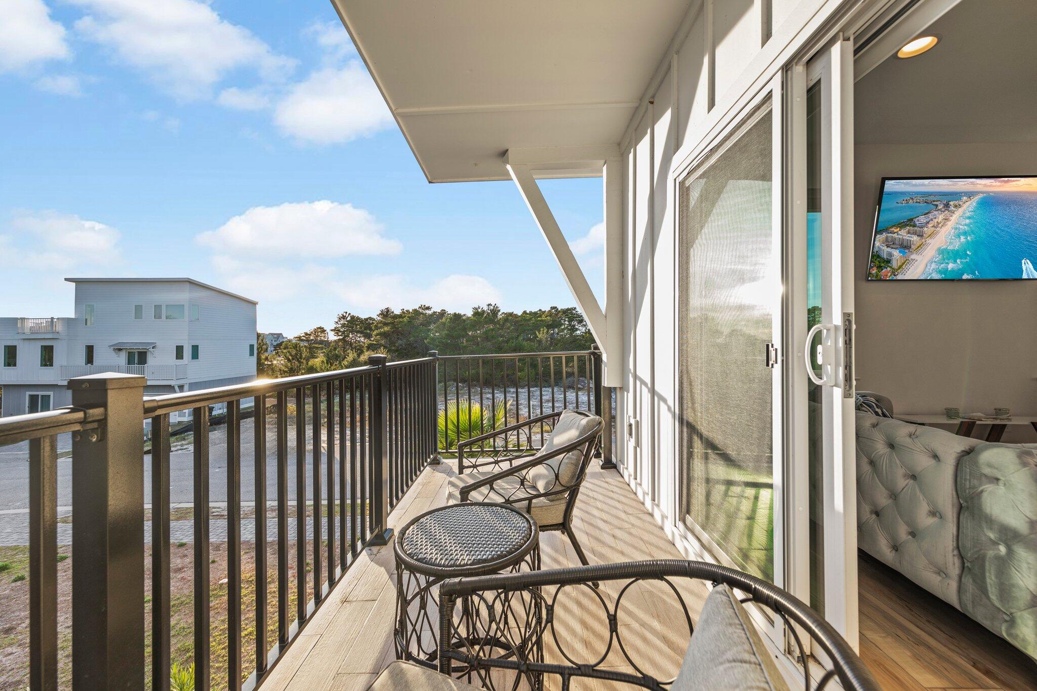 29 Seaview Dr Inlet Beach Inlet Beach, FL 32461 - Photo 48 of 52 a view of a balcony with furniture and wooden floor
