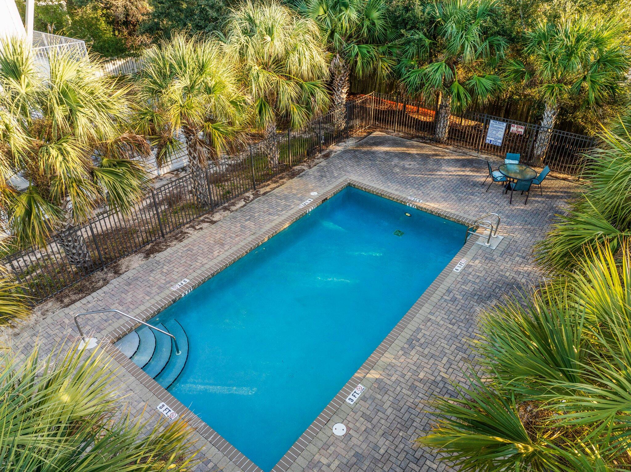 29 Seaview Dr Inlet Beach Inlet Beach, FL 32461 - Photo 51 of 52 a view of a swimming pool with lawn chairs and plants