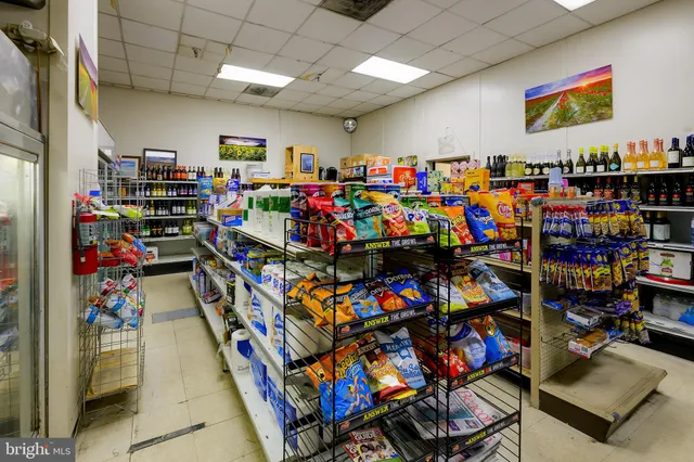 a living room with furniture and a book shelf