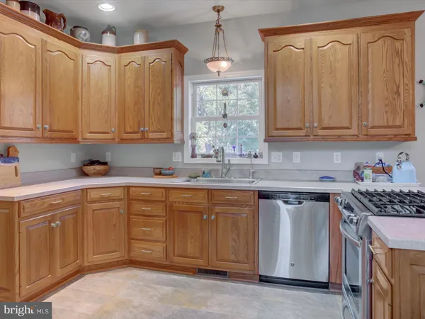 a living room with furniture fireplace and a large window