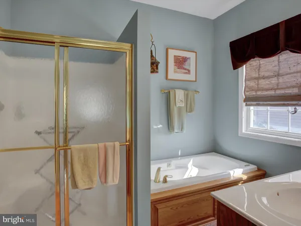 a spacious bathroom with a granite countertop sink a toilet and a mirror