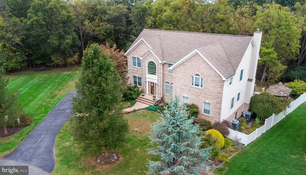 a aerial view of a house with yard and green space