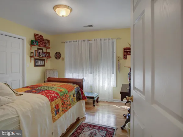 a bedroom with a bed and painting on the wall