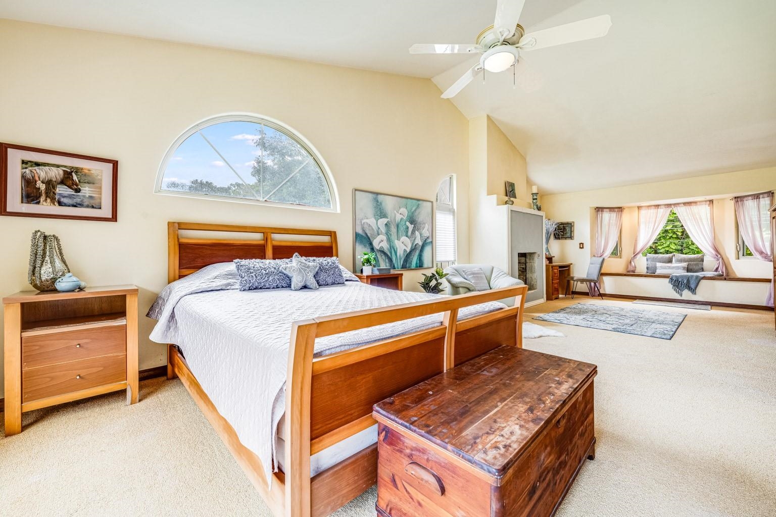 592 Kaupakalua Road Haiku, HI 96708 - Photo 11 of 28 a bedroom with a bed a chandelier and a dresser