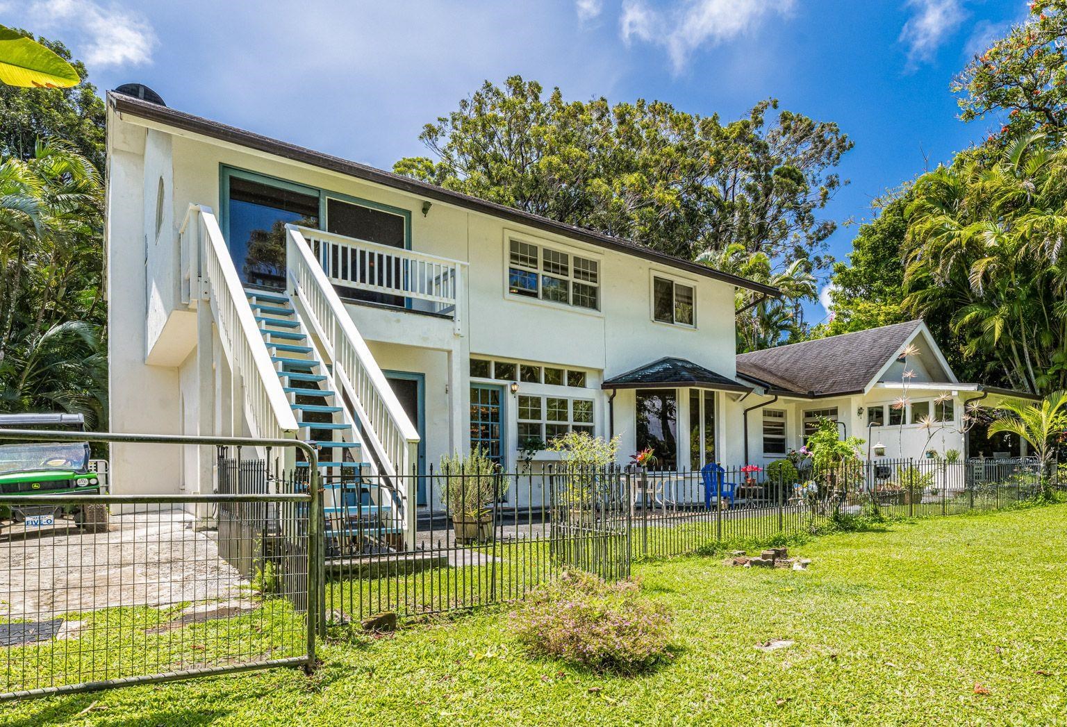 592 Kaupakalua Road Haiku, HI 96708 - Photo 19 of 28 a front view of a house with a yard table and chairs