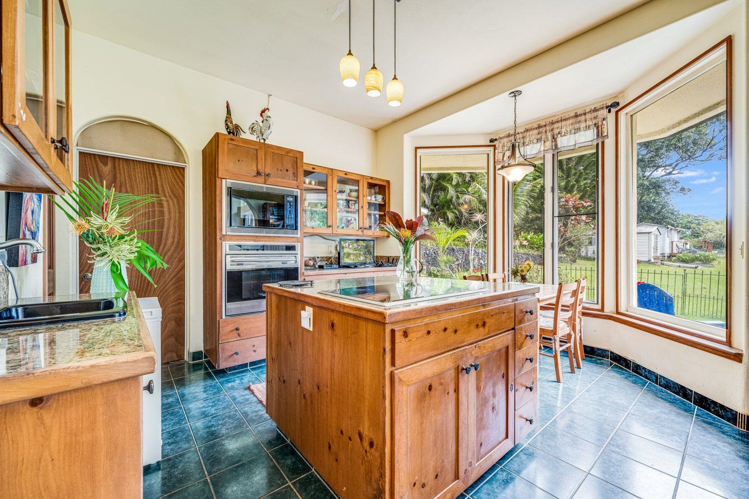592 Kaupakalua Road Haiku, HI 96708 - Photo 8 of 28 a kitchen with stainless steel appliances granite countertop a stove and a refrigerator