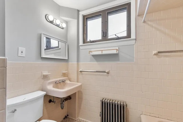 a bathroom with a sink a mirror and a toilet