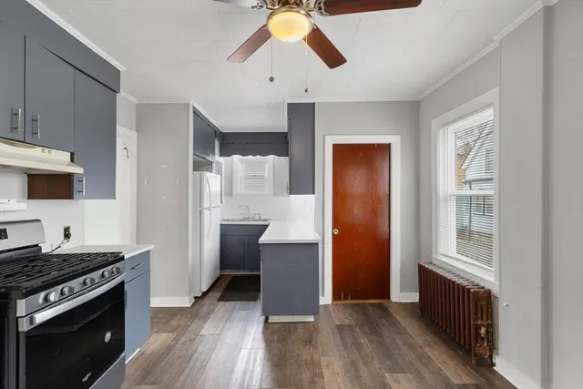 a kitchen with a refrigerator and a stove top oven