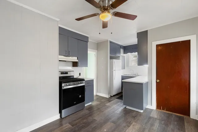 a kitchen with granite countertop a stove and a refrigerator