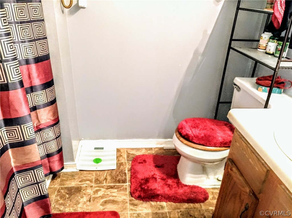 6707 Huntsville Road Chesterfield, VA 23832 - Photo 11 of 17 a bathroom with a sink toilet and mirror