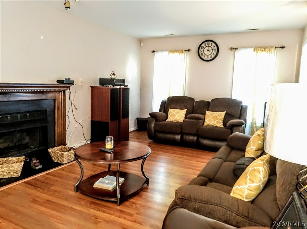 6707 Huntsville Road Chesterfield, VA 23832 - Photo 4 of 17 a living room with furniture a rug and a fireplace