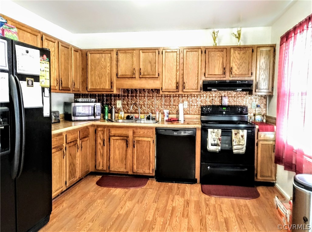 6707 Huntsville Road Chesterfield, VA 23832 - Photo 6 of 17 a kitchen with stainless steel appliances a refrigerator sink and cabinets