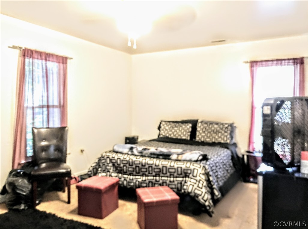 6707 Huntsville Road Chesterfield, VA 23832 - Photo 9 of 17 a bedroom with a bed and wooden floor