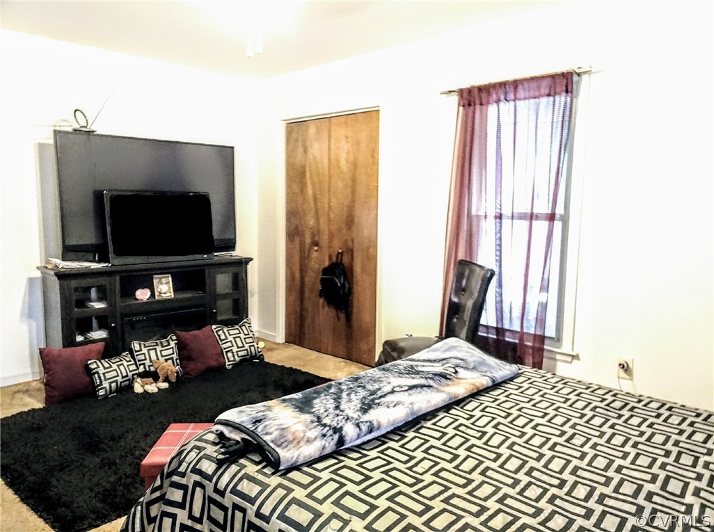6707 Huntsville Road Chesterfield, VA 23832 - Photo 10 of 17 a bedroom with a bed and a flat screen tv
