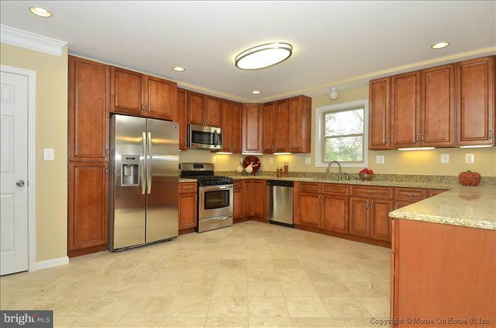 10302 Ridgemoor Drive Silver Spring, MD 20901 - Photo 12 of 16 a kitchen with stainless steel appliances granite countertop a refrigerator sink and cabinets