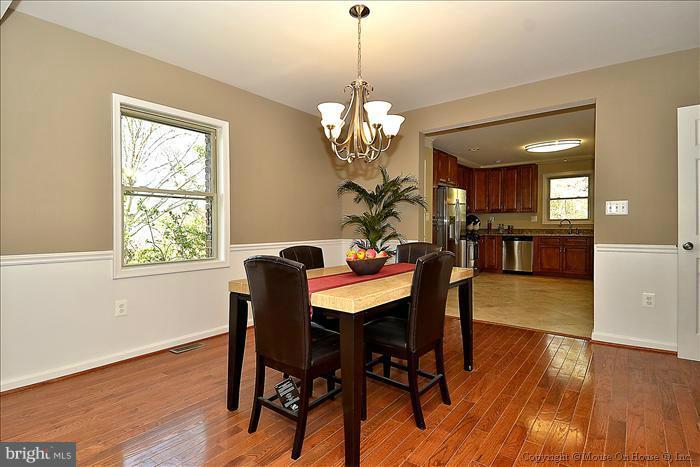 10302 Ridgemoor Drive Silver Spring, MD 20901 - Photo 15 of 16 a dining room filled chandelier and wooden floor