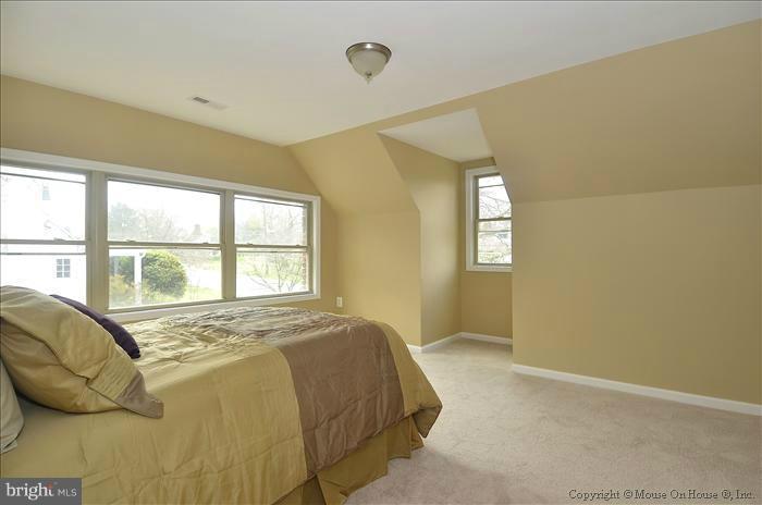 10302 Ridgemoor Drive Silver Spring, MD 20901 - Photo 16 of 16 a spacious bedroom with a bed and a window
