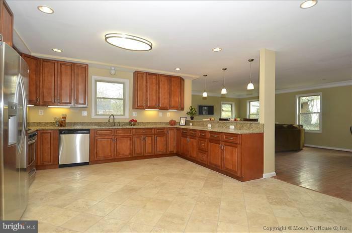 10302 Ridgemoor Drive Silver Spring, MD 20901 - Photo 5 of 16 a kitchen with stainless steel appliances granite countertop a stove sink and cabinets
