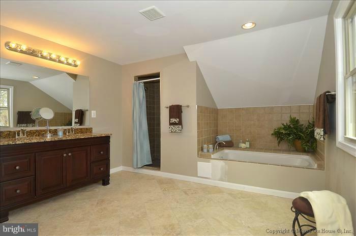 10302 Ridgemoor Drive Silver Spring, MD 20901 - Photo 8 of 16 a spacious bathroom with a granite countertop sink and a mirror