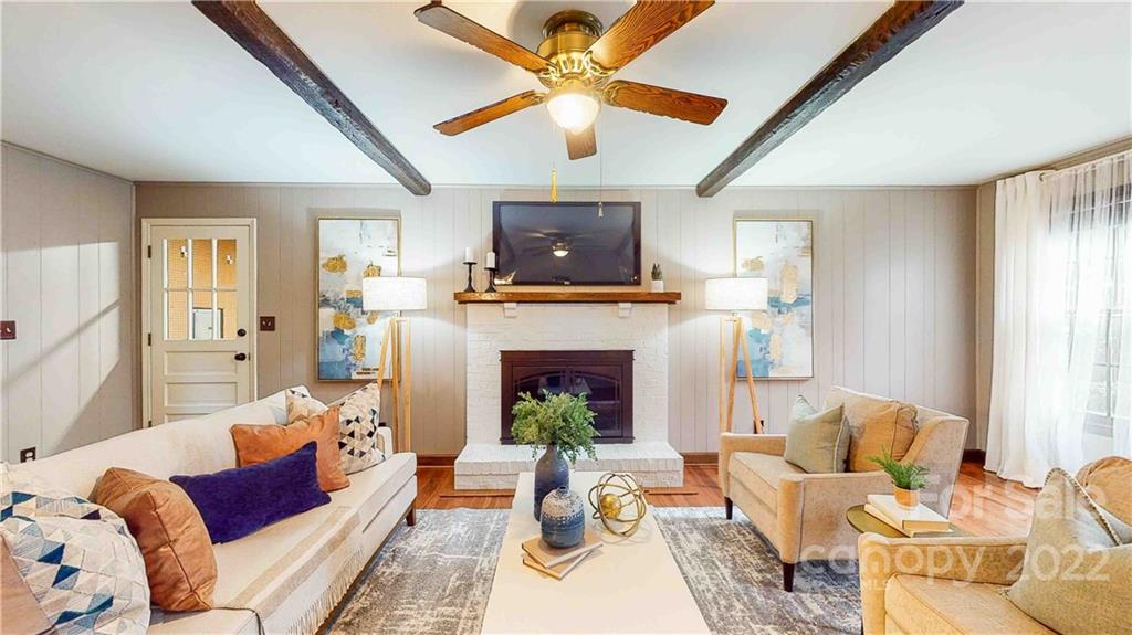 6620 Fairlawn Road Charlotte, NC 28215 - Photo 15 of 43 a living room with furniture a fireplace and a large window