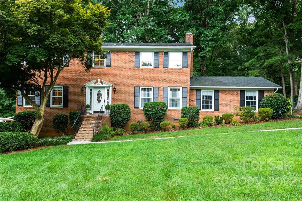 6620 Fairlawn Road Charlotte, NC 28215 - Photo 2 of 43 a front view of a house with a yard and green space