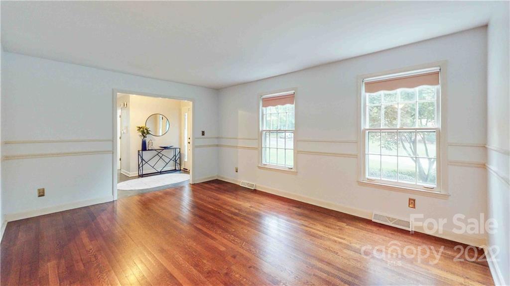 6620 Fairlawn Road Charlotte, NC 28215 - Photo 23 of 43 an empty room with wooden floor and a window