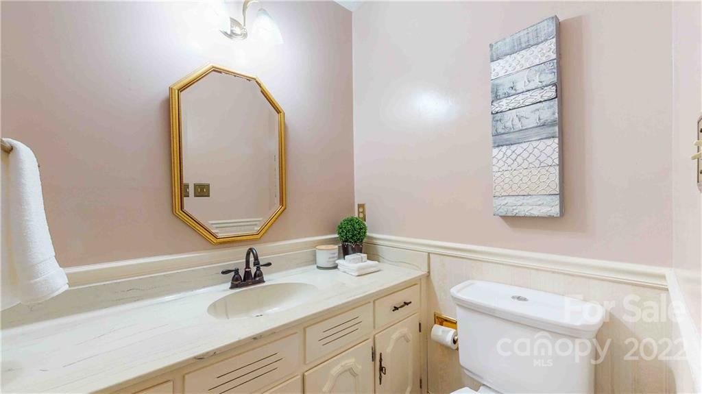 6620 Fairlawn Road Charlotte, NC 28215 - Photo 24 of 43 a bathroom with a granite countertop toilet sink and mirror