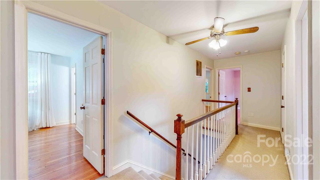 6620 Fairlawn Road Charlotte, NC 28215 - Photo 25 of 43 a view of a hallway with wooden floor and staircase