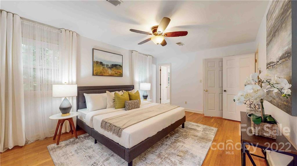 6620 Fairlawn Road Charlotte, NC 28215 - Photo 26 of 43 a bedroom with a bed and a chandelier