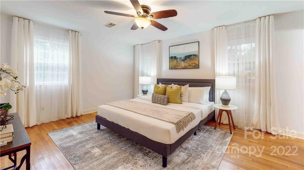 6620 Fairlawn Road Charlotte, NC 28215 - Photo 27 of 43 a bedroom with a bed and wooden floor