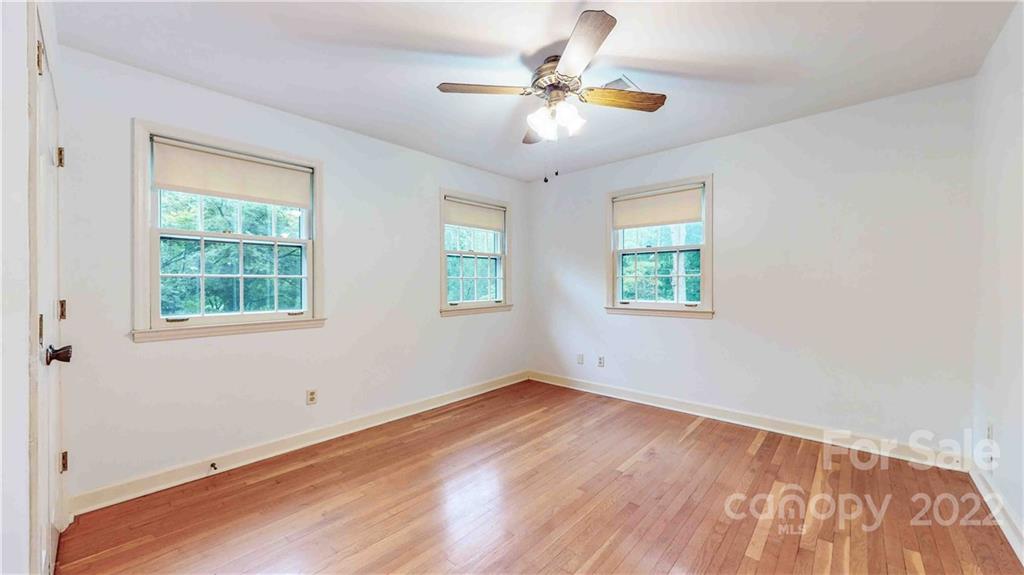 6620 Fairlawn Road Charlotte, NC 28215 - Photo 35 of 43 wooden floor in an empty room with a window