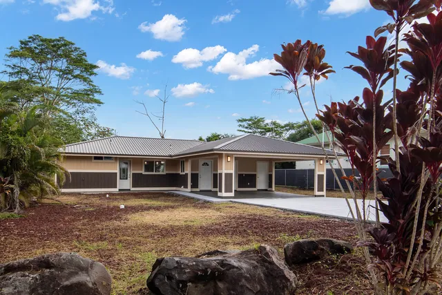 a front view of a house with a garden