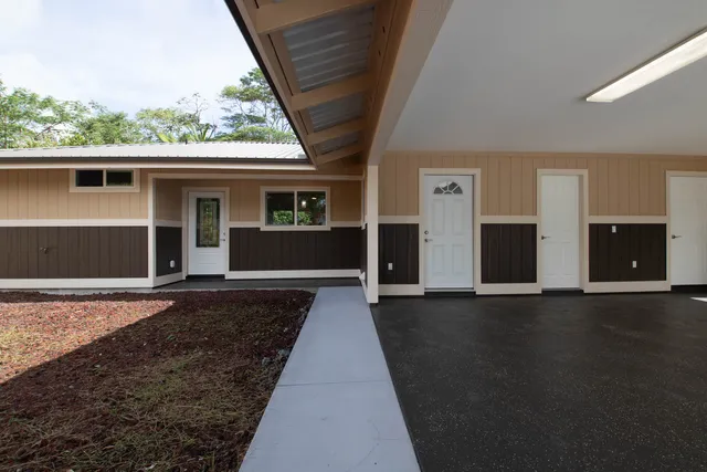 a view of house with outdoor space and swimming pool