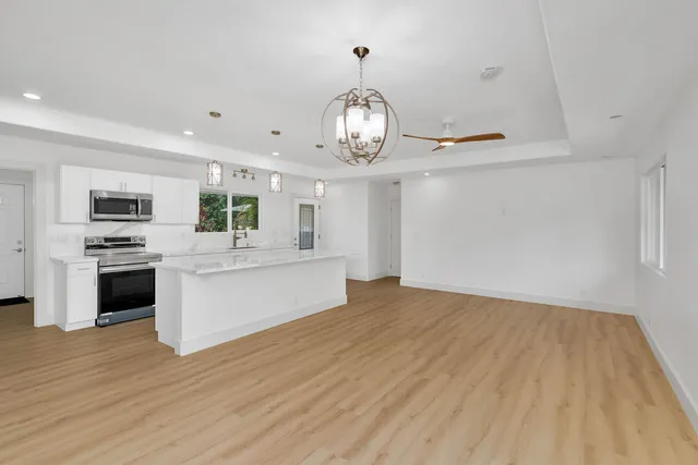 a view of a kitchen with stove and cabinets
