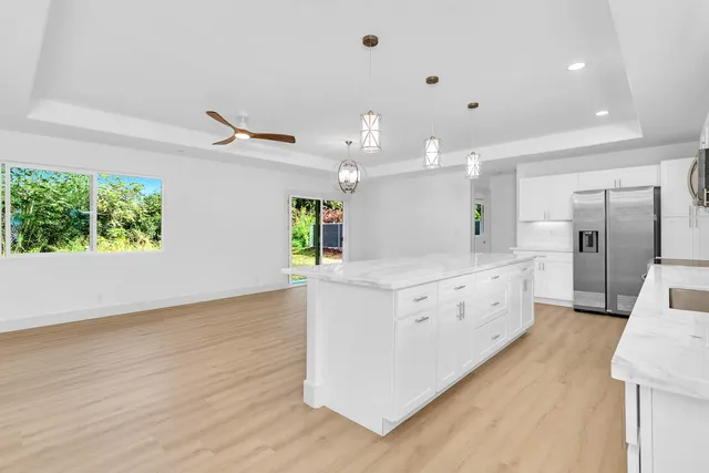 a large kitchen with a large window a counter space and stainless steel appliances