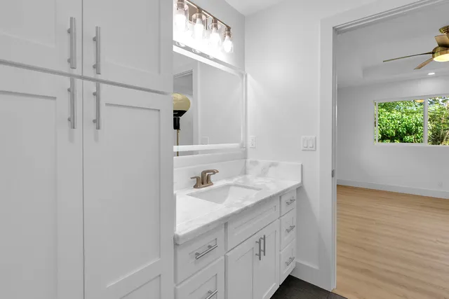 a spacious bathroom with a sink and a mirror