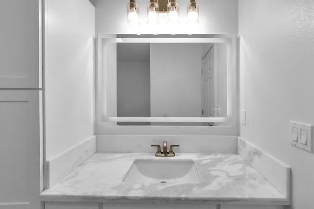 a bathroom with a sink and a mirror