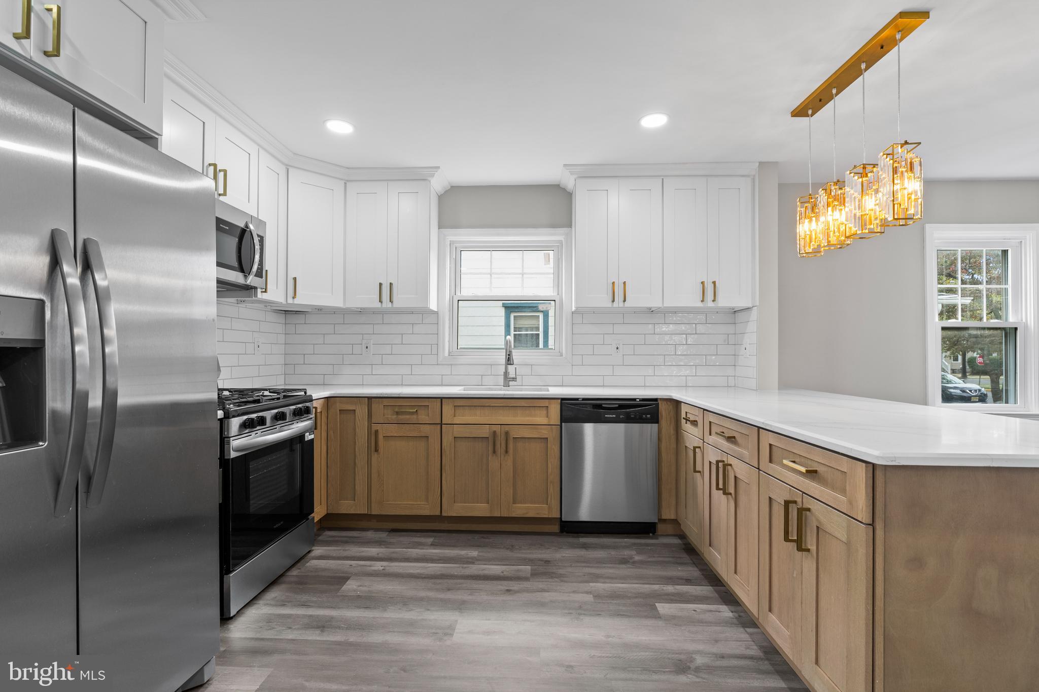 131 Lippincott Avenue Riverside, NJ 08075 - Photo 11 of 34 a kitchen with stainless steel appliances granite countertop a kitchen island a stove and a sink