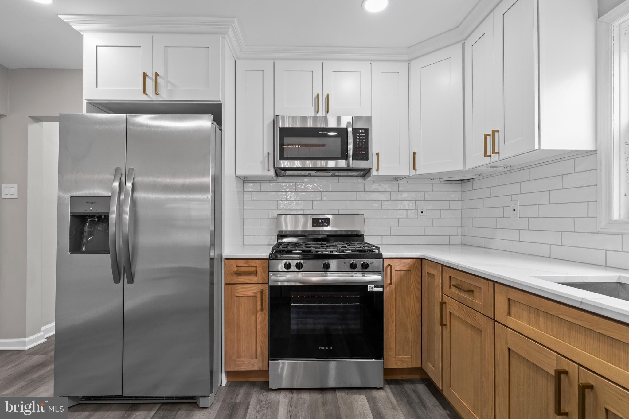 131 Lippincott Avenue Riverside, NJ 08075 - Photo 14 of 34 a kitchen with cabinets stainless steel appliances and wooden floor