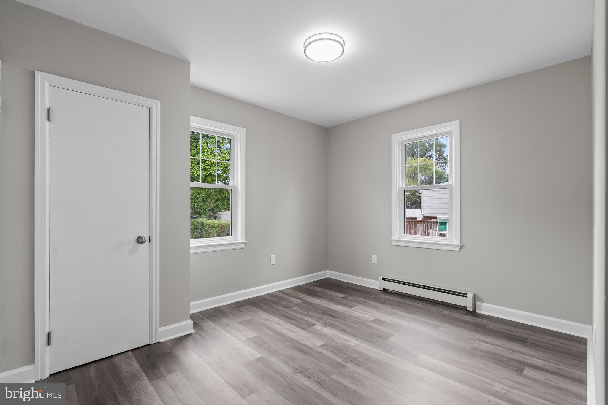 131 Lippincott Avenue Riverside, NJ 08075 - Photo 15 of 34 an empty room with wooden floor and windows