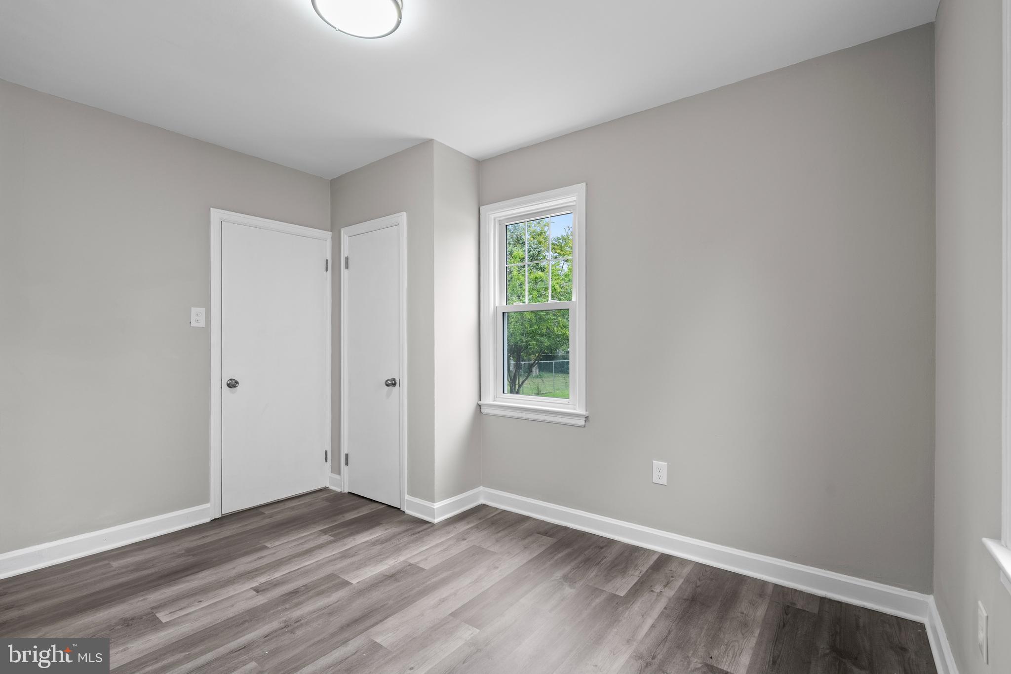 131 Lippincott Avenue Riverside, NJ 08075 - Photo 16 of 34 a view of an empty room with wooden floor and a window