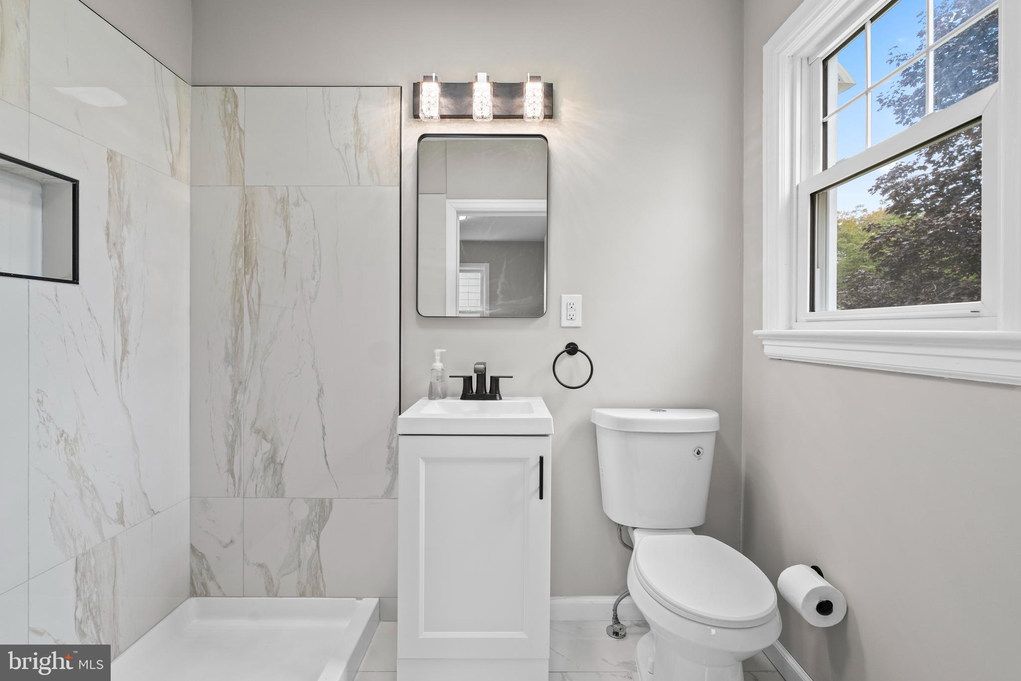 131 Lippincott Avenue Riverside, NJ 08075 - Photo 17 of 34 a white toilet sitting next to a bathroom sink